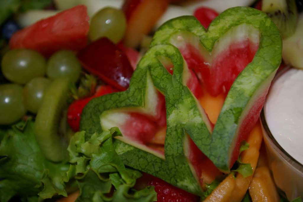 entwined hearts made from watermelon rind on fruit tray